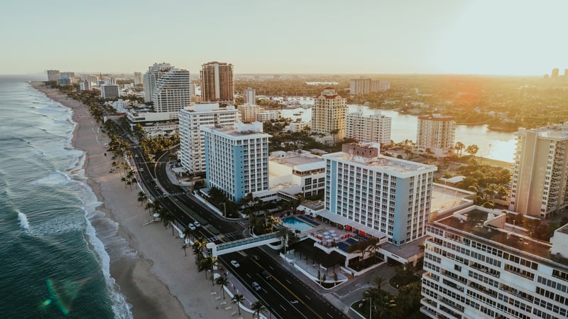 Aerial view of Fort Lauderdale Beach, Florida, with beachfront buildings beside the Atlantic Ocean.