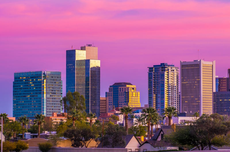 Downtown Phoenix, Arizona, beneath pink and purple clouds at dusk.