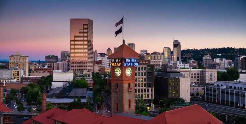 Union Station's clock tower and downtown Portland, Oregon, at sunset.