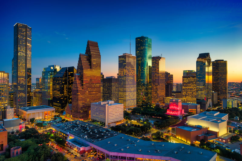 Downtown Houston, Texas, at dusk, with sunset light reflecting off the office towers.