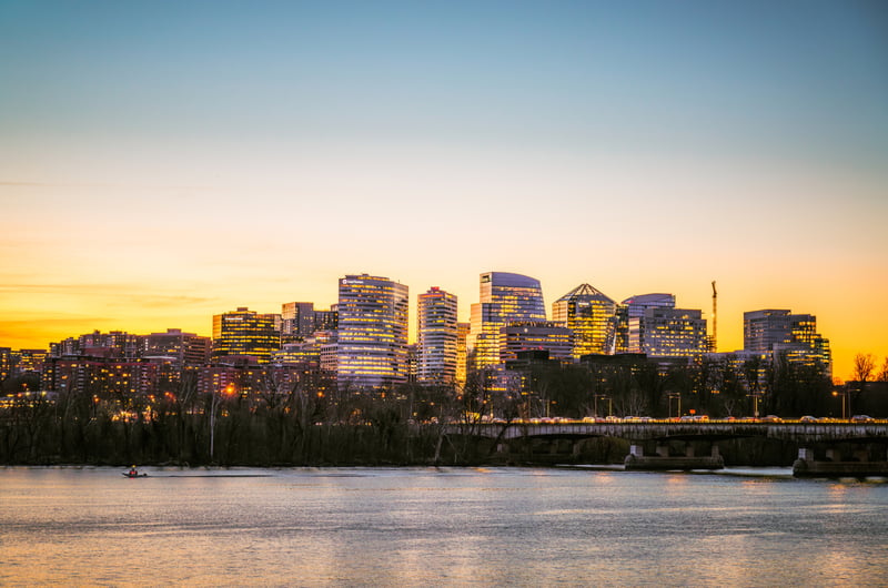 Rosslyn skyline in Arlington County, Virginia, across the Potomac River and Key Bridge at dusk.