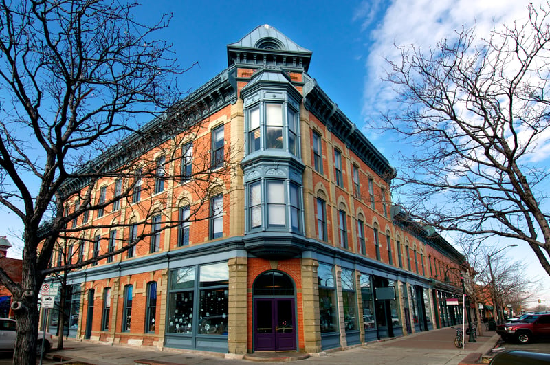 Historic brick storefronts and a corner building in downtown Fort Collins, Colorado.