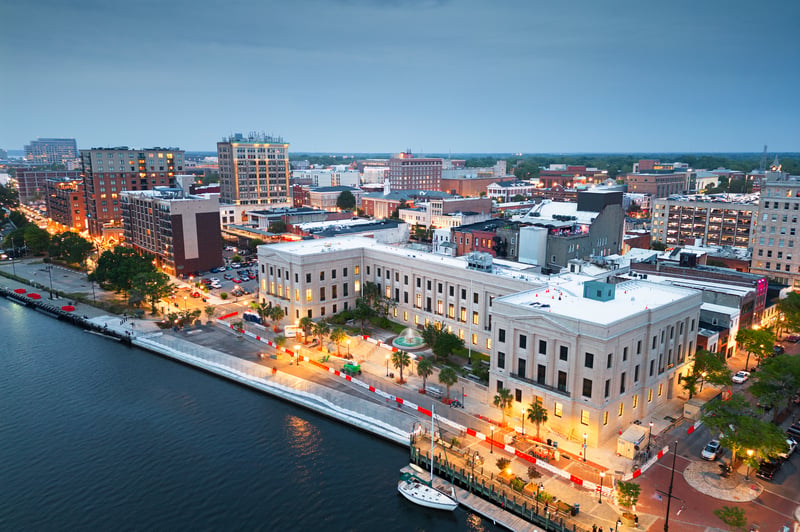 Downtown Wilmington, North Carolina, and the Riverwalk along the Cape Fear River at dusk.
