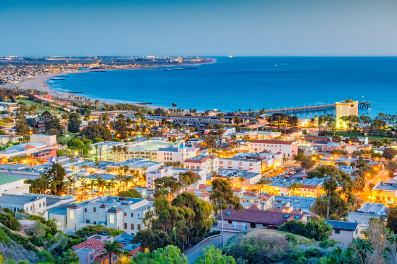Ventura, California, at twilight, with the coastline and pier beside the city.