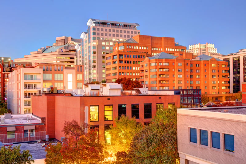 Downtown Bethesda, Maryland, with brick buildings and illuminated streets at dusk.