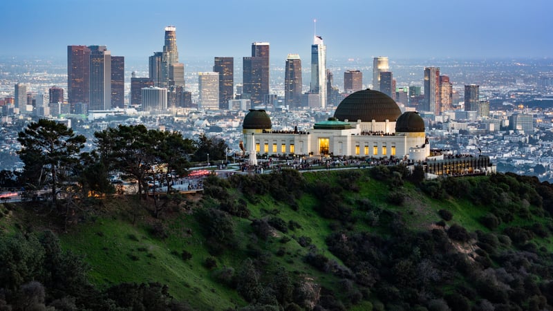 Griffith Observatory overlooking the Los Angeles skyline at dusk.