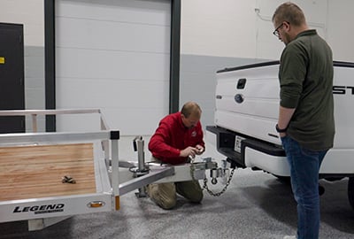The safety chains on a trailer are attached to the tow vehicle.