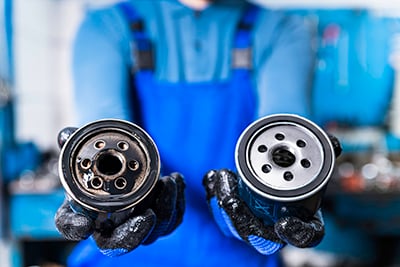 An old oil filter is compared to a new one.