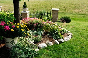 Natural rock edging can be a very cheap and beautiful way to spruce up your flower bed.
