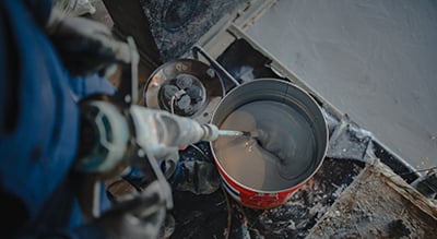 Epoxy is mixed before being applied to a floor.