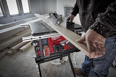 A board is ripped on a Milwaukee M18 FUEL 8-1/4 inch Table Saw