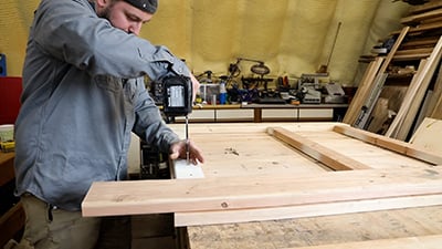 The cut 2x4-inch boards are screwed into the 2x10s.